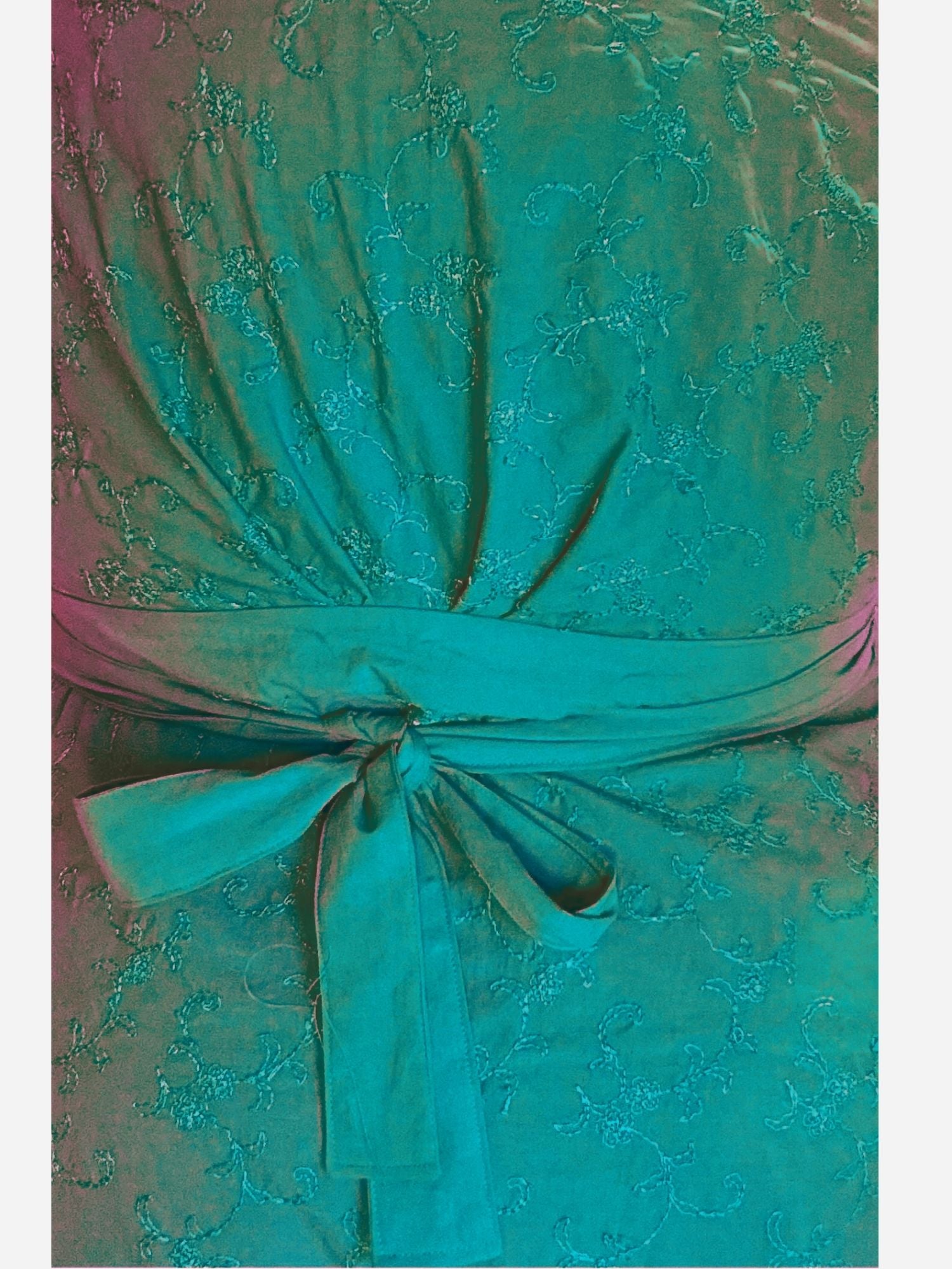 Close-up of a pink lace dress with a bow detail.