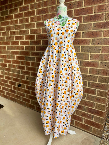 Spots dress on a mannequin against a brick wall