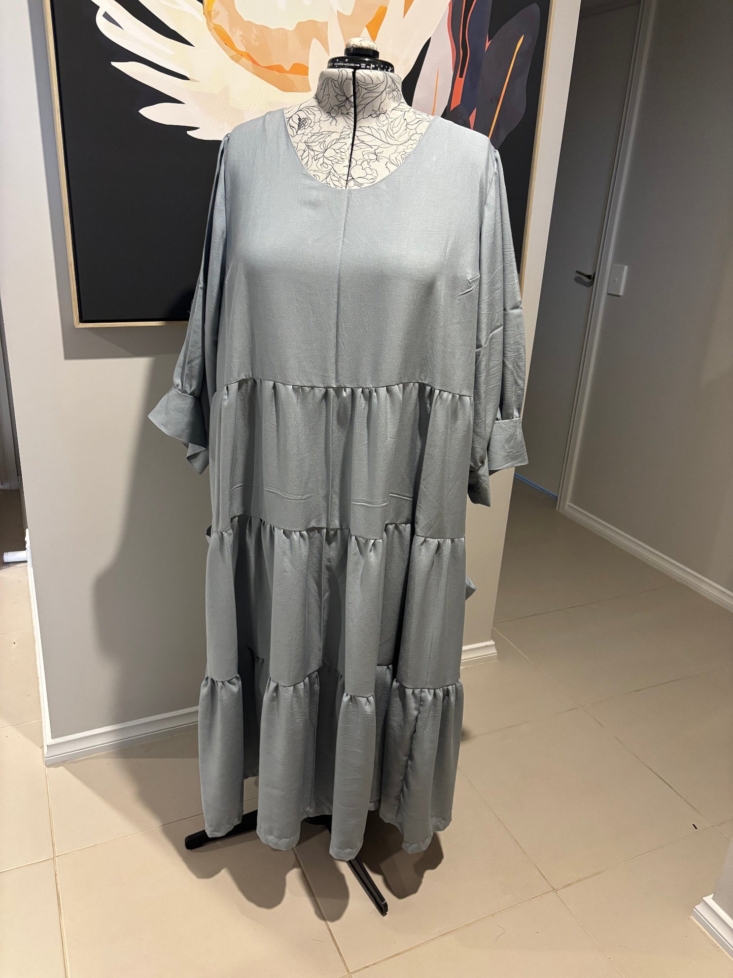 Blue gray dress on a mannequin in a store setting