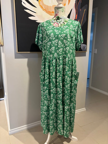 Green floral-patterned fabric on a white surface with a blurred background